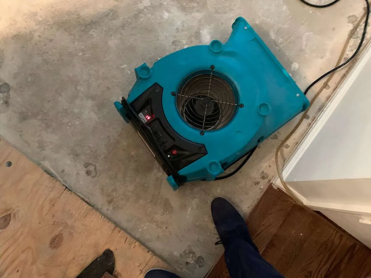 Air mover drying subfloor during Commercial Water Damage Restoration in Arden Hills